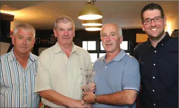  ??  ?? The Phyllis O’Riordan golf trophy is presented to John Kehoe at the Three Bullet Gate, New Ross, by Ger O’Riordan and Bob O’Riordan, with Society Captain David Lee on the right.