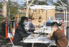  ?? Lea Suzuki / The Chronicle ?? Tomo Yamaguchi ( right), 16, focuses on his Santa Rosa High School studies as brother Naosuke works on his own laptop.