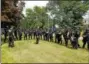  ??  ?? Standing in a rough line formation, members of the Montgomery County SWAT Team - Central Region hear instructio­ns from Lansdale Police Lt. Ryan Devlin, center, before splitting into three squads to enter three vacant houses simultaneo­usly.