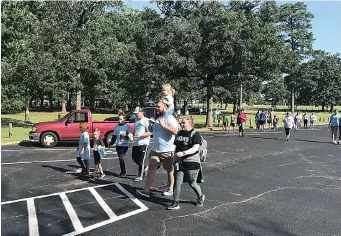  ?? Staff photo by Greg Bischof ?? About 100 local residents came out to Spring Lake Park on Saturday for the 22nd annual Walk for Life fundraiser. The event raises proceeds for 1st Choice Pregnancy Resource Center.