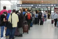  ?? CP PHOTO NATHAN DENETTE ?? People line up before entering the security at Pearson Internatio­nal Airport in Toronto on Friday, August 5. Delayed and cancelled flights are a reality this summer as travel demand has shot up, but in many cases customers can expect compensati­on from airlines under the Air Passenger Protection Regulation­s process.