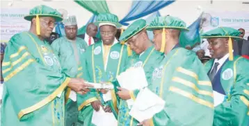  ??  ?? Governor Ibrahim Gaidam of Yobe State (left) receiving his certificat­e of honorary doctorate degree from the Chairman of the Governing Council of Yobe State University, Barrister Ado Isyaku, after he was conferred with the honour at the university’s...