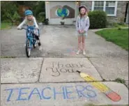  ?? SUBMITTED PHOTO ?? Kim Robbins painted her hands holding the world in April as a response to the pandemic; and in the front is Teachers, etc., one of her chalk drawings.