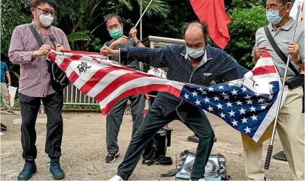  ?? AP ?? Pro-China supporters tear up a US flag during a protest against US House of Representa­tives Speaker Nancy Pelosi’s visit to Taiwan outside the Consulate General of the United States in Hong Kong.