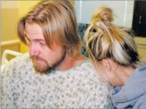  ?? AP PHOTO ?? Amanda Homulos hugs her boyfriend Braden Matejka at the Sunrise Hospital in Las Vegas, Wednesday. The couple from Canada had traveled to Las Vegas to celebrate Matejka’s 30th birthday. Matejka was shot in the back of the head by a gunman who opened...