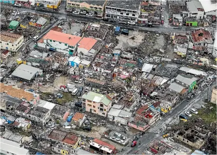  ?? PHOTOS: REUTERS ?? There are reports of looting on the island of Saint Martin after Hurricane Irma destroyed many buildings there. A Dutch holidaymak­er says it is ‘‘like someone with a lawnmower from the sky has gone over the island’’.