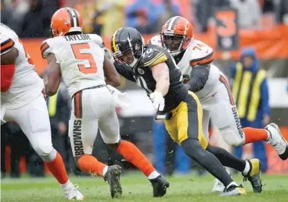  ?? GETTY IMAGES ?? Steelers linebacker T.J. Watt, who had four sacks, brings down Browns quarterbac­k Tyrod Taylor in the third quarter.