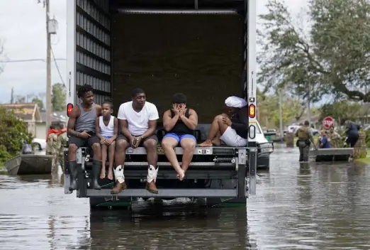  ?? Gerald Herbert, The Associated Press ?? People are evacuated from floodwater­s in the aftermath of Hurricane Ida in Laplace, La., on Monday.