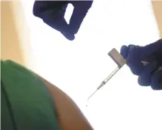  ?? DAVID GOLDMAN/AP ?? A droplet falls from a syringe after a health care worker was injected with the Pfizer-BioNTech COVID-19 vaccine Dec. 15 in Providence, Rhode Island.