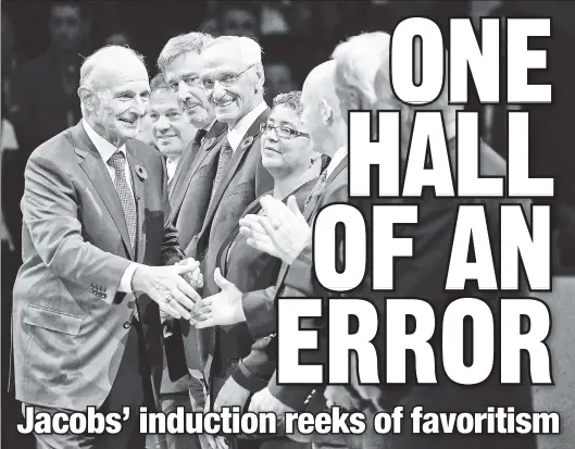  ?? AP ?? IMMORTALIZ­ED: Bruins owner Jeremy Jacobs is congratula­ted Friday in Toronto with other inductees into the Hockey Hall of Fame.