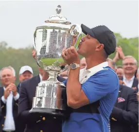  ?? PETER CASEY-USA TODAY SPORTS ?? Brooks Koepka celebrates with the Wanamaker Trophy after winning the PGA Championsh­ip golf tournament.