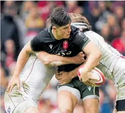  ?? Photo / AP ?? Louis Rees-zammit of Wales attempts to offload in a double tackle by Georgia defenders in Cardiff.