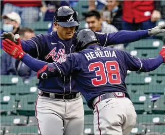  ?? NAM Y. HUH/ASSOCIATED PRESS ?? Guillermo Heredia is greeted by Austin Riley after hitting a two-run home run during the first inning Sunday night in Chicago. He later hit a grand slam. The Braves have gotten seven home runs and 19 RBIS from bench players Pablo Sandoval, Ehire Adrianza and Heredia.