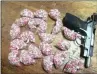  ??  ?? Drug capsules and an unlicensed firearm recovered in Phoenix on Friday.