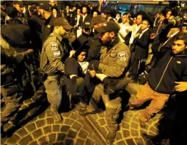  ?? (Marc Israel Sellem/The Jerusalem Post) ?? YESHIVA STUDENTS loyal to the extremist Jerusalem Faction bring traffic on Yafo Street in Jerusalem to a stop last night.