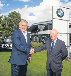  ??  ?? Keith Duncan, the Dundee-raised managing director of Eastern Western Motor Group, with Colin Grassick at Grassicks BMW and Mini, Inveralmon­d, Perth.