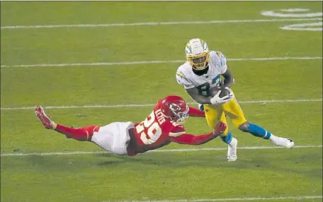  ?? TYRON JOHNSON Charlie Riedel Associated Press ?? breaks a tackle by Chiefs cornerback BoPete Keyes ( 29) in a Chargers win that leads into an interestin­g offseason.