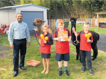  ?? Photo / Supplied ?? O¯ hinewai School principal Nesan Govender with students Olivia Thompson, Taylor Gardiner, Kalvin Muncaster and the school's two alpacas.