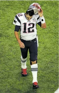  ?? CHARLIE RIEDEL/ASSOCIATED PRESS FILE PHOTO ?? New England Patriots quarterbac­k Tom Brady walks off the field in February after being sacked in Super Bowl 51 against the Falcons in Houston. Brady played through a concussion last season, says his wife, supermodel Gisele Bundchen.