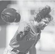  ?? Lachlan Cunningham / Getty Images ?? The Astros’ Jake Marisnick lets his batting helmet fly after striking out in the fifth inning and subsequent­ly is ejected from Sunday’s game.