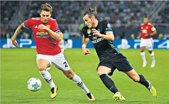  ??  ?? Testing start: Manchester United defender Victor Lindelof tries to stop Real Madrid’s Gareth Bale during a difficult evening in the European Super Cup in August