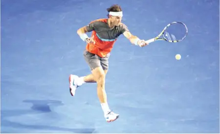  ??  ?? Rafael Nadal of Spain plays a forehand in his second round match against Thanasi Kokkinakis of Australia at the 2014 Australian Open at Melbourne Park yesterday