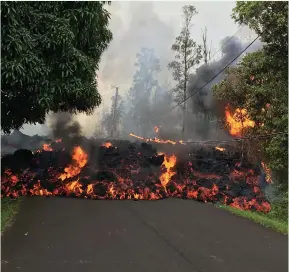  ?? (United States Geological Survey/handout via Reuters) ?? LAVA FROM the Kilauea volcano flows on a street in Leilani Estates in Hawaii on Sunday. Kilauea has destroyed 26 homes and forced 1,700 people to leave their residences since it erupted on Thursday.