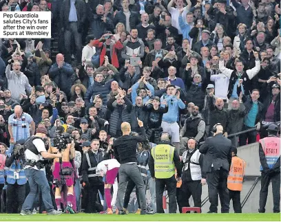  ??  ?? Pep Guardiola salutes City’s fans after the win over Spurs at Wembley