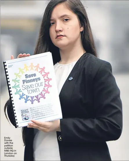  ??  ?? Emily Davies with the petition outside M&amp;S HQ in London on Thursday