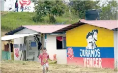  ??  ?? Un niño en una de las zonas de reincorpor­ación, en Tolima, donde ex gerrillero­s son auxiliados para regresar a la vida civil.