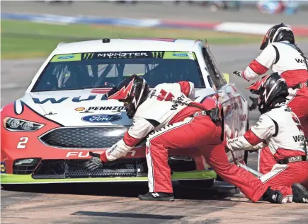  ??  ?? The pit crew for Brad Keselowski works on his car after it made contact with another car at the start of Sunday’s race. JEROME MIRON/USA TODAY SPORTS