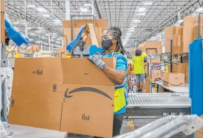  ?? Elizabeth Brumley Las Vegas Review-journal ?? Associate Lola Wickett packages products in July at an Amazon warehouse in North Las Vegas. Amazon broke ground nearby on a 855,000-square-foot building in October and is planning more facilities next year in the Las Vegas Valley.