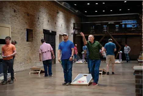  ?? Staff photo by Kelsi Brinkmeyer ?? ■ Cornhole players from across the Texarkana region meet on Tuesday nights at Crossties for a weekly tournament hosted by Ark-La-Tex Baggers.