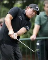  ?? JEFF SINER - THE ASSOCIATED PRESS ?? Phil Mickelson watches the flight of his ball during practice for the PGA Championsh­ip golf tournament at Quail Hollow Club in Charlotte, N.C., on Monday.