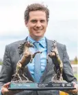  ??  ?? Trainer Matt Cumani poses with The Showdown trophy