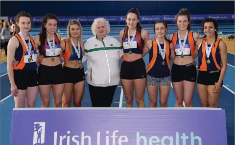  ??  ?? Athletics Ireland President Georgina Drumm with the Slí Cualann AC team from Wicklow, who finished second in the women’s competitio­n during the Irish Life Health National Indoor Club League fsinal at the Sport Ireland National Indoor Arena in...
