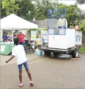  ?? Katie West • Times-Herald ?? A St. Francis County 4-H group participat­ed in the farmers market on Saturday at the Forrest City Civic Center. The youngsters sold baked goods and hosted a dunking booth for people to enjoy. Members of 4-H and leaders took turns getting into the dunking booth.