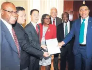  ?? LIONEL ROOKWOOD/PHOTOGRAPH­ER ?? Prime Minister Andrew Holness (right) along with Niu Qingbao, Chinese Ambassador (third left) and Liu Xiangang, project manager China Harbour Engineerin­g Company. (second left) with the signed contract. Others in the picture (from left) are E. G. Hunter, CEO, the National Works Agency; Audrey Sewell, permanent secretary in the office of the Prime Minister; Delroy Chuck and Everald Warmington, members of parliament.