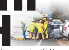  ??  ?? TRAGIC SCENE: Emergency services personnel assist victims of a highway collision near Mareeba. Picture: STEWART McLEAN