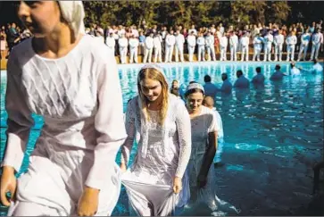  ?? Max Whittaker For The Times ?? MEMBERS OF Bethany Slavic Missionary Church in Sacramento, pictured at a baptism ceremony last month, routinely drank church well water contaminat­ed by firefighti­ng foam from a former Air Force base.