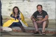  ?? AP PHOTO/ MARK J. TERRILL ?? Potential witnesses sit near the scene Thursday, Nov. 8, 2018, in Thousand Oaks, Calif., where a gunman opened fire Wednesday inside a crowded country music bar.