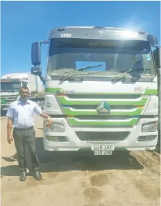  ?? ?? Xclent Transport Pte Limited’s director Tarik Hussein beside one of his cargo service truck.