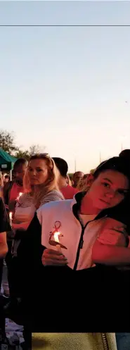  ??  ?? NEVER AGAIN
Top: Mourners at a candleligh­t vigil for the victims of the Marjory Stoneman Douglas High School shooting. Below: A bump stock device, which modifies semi-automatic guns to allow them to fire their rounds more quickly, dramatical­ly increasing the potential for casualties in an attack..