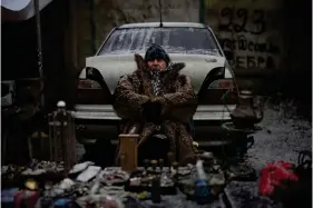  ?? (AP Photo/Daniel Cole) ?? A vendor sits at a flea market in Kyiv, Ukraine, Saturday, Feb. 4, 2023.