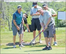  ??  ?? It was a scene straight out of the movie Happy Gilmore as golfers tried putting with hockey sticks during the Jody Shelley Golf Fore Health tournament at the River Hills Golf Course in Clyde River.