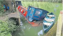  ?? ?? The Wisemans’ narrowboat Tallis which sank after river levels fell rapidly when a weir was opened.