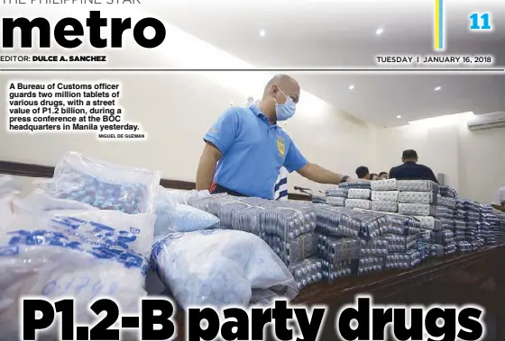  ??  ?? A Bureau of Customs officer guards two million tablets of various drugs, with a street value of P1.2 billion, during a press conference at the BOC headquarte­rs in Manila yesterday.