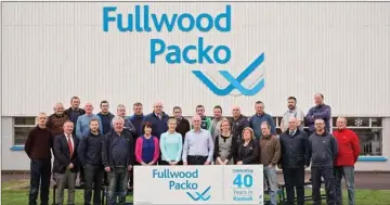  ??  ?? Photo downloaded from the Fullwood Packo website showing staff cekebratin­g 40 years in Kanturk just a few years ago.