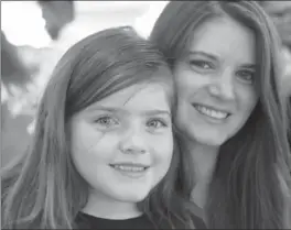  ?? CARL JUSTE, MIAMI HERALD ?? Valerie Bunt, 33, right, was diagnosed with breast cancer when she was 26. Her daughter, Alyssa, 8, is wearing pink hair extensions for Breast Cancer Awareness Month.