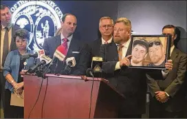  ?? MEG KINNARD / AP ?? South Carolina Attorney General Alan Wilson (left) stands next to Rep. Eric Bedingfiel­d, whose son died last year of a drug overdose, Tuesday at his offices in Columbia, S.C. Wilson on Tuesday announced the state had sued Purdue Pharma, accusing the...